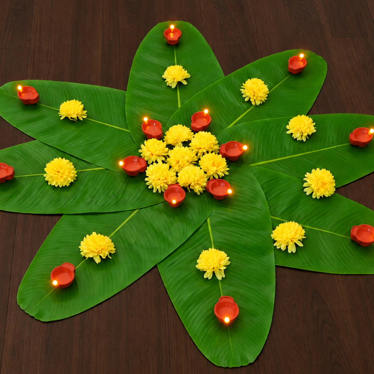 Banana leaf rangoli opened out with LED diyas set towards the leaf tips