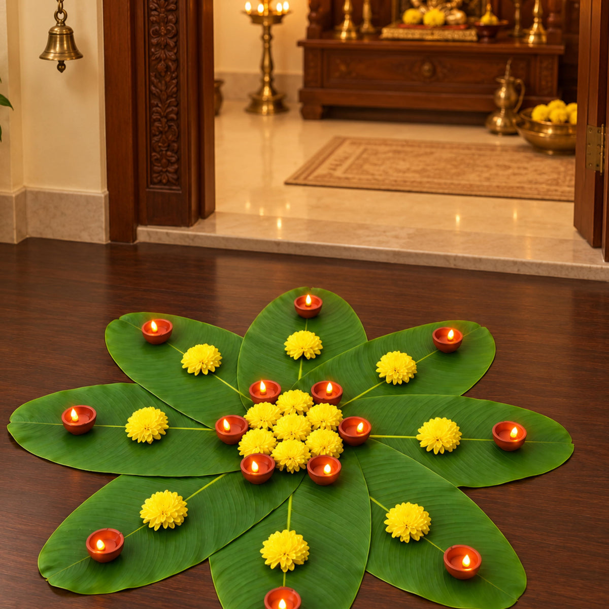 Banana leaf rangoli lit on the floor at the entrance to the pooja room