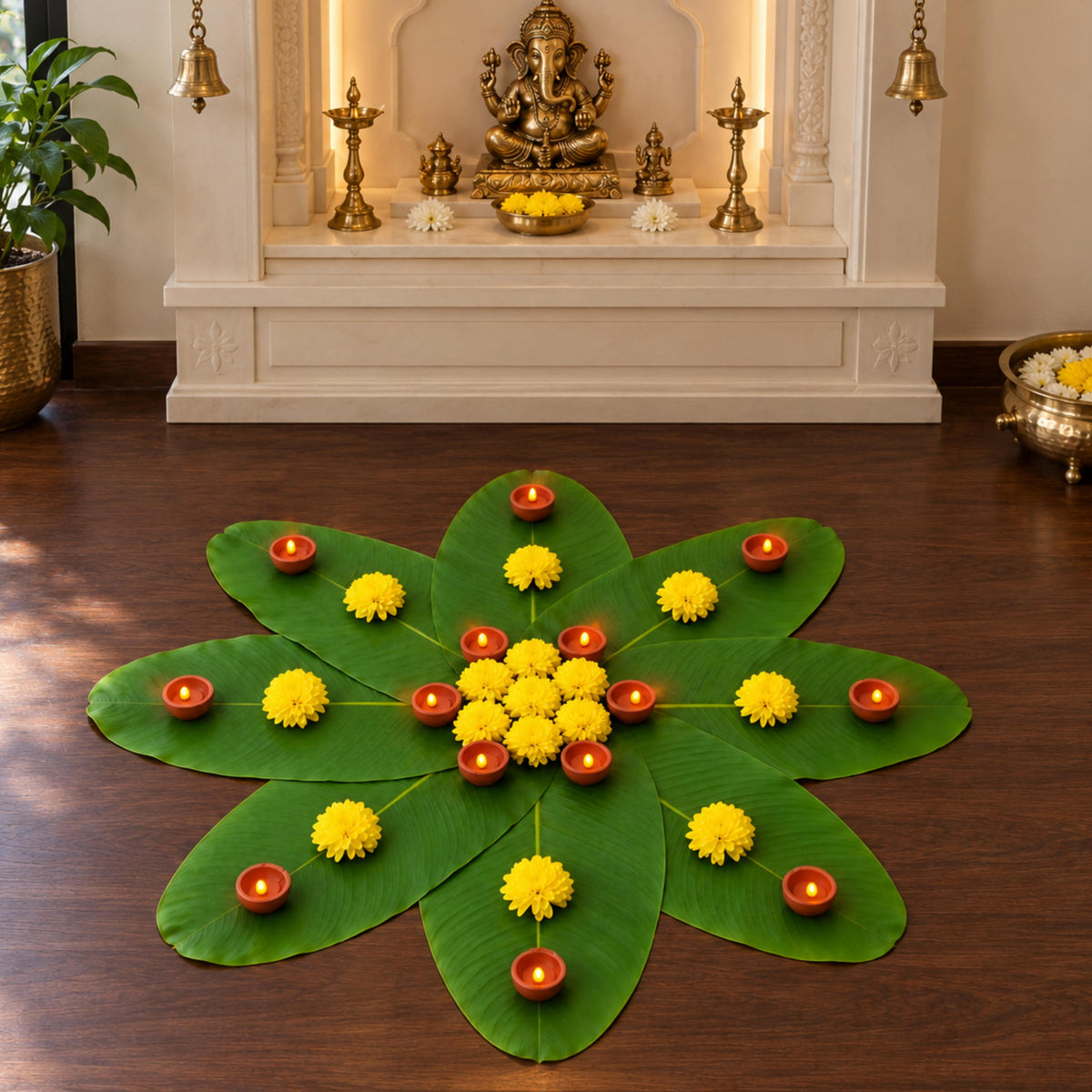 Banana leaf rangoli with LED diyas and marigolds in front of the mandir