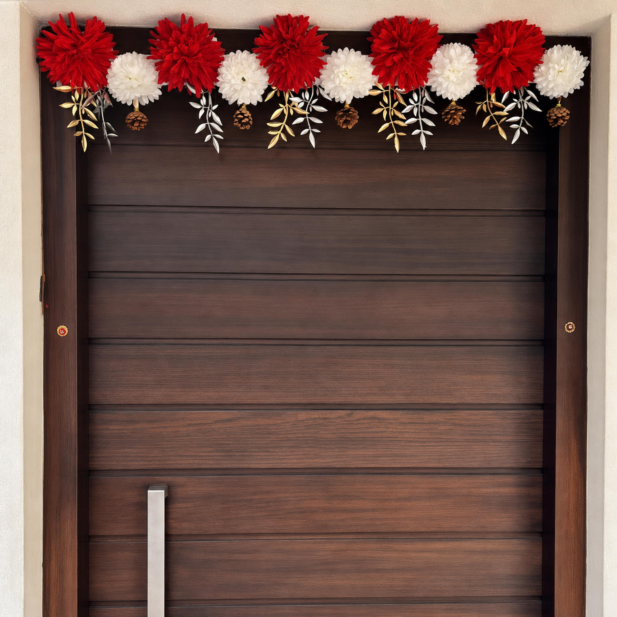 Red and white flower toran with gold leaves across a wood door