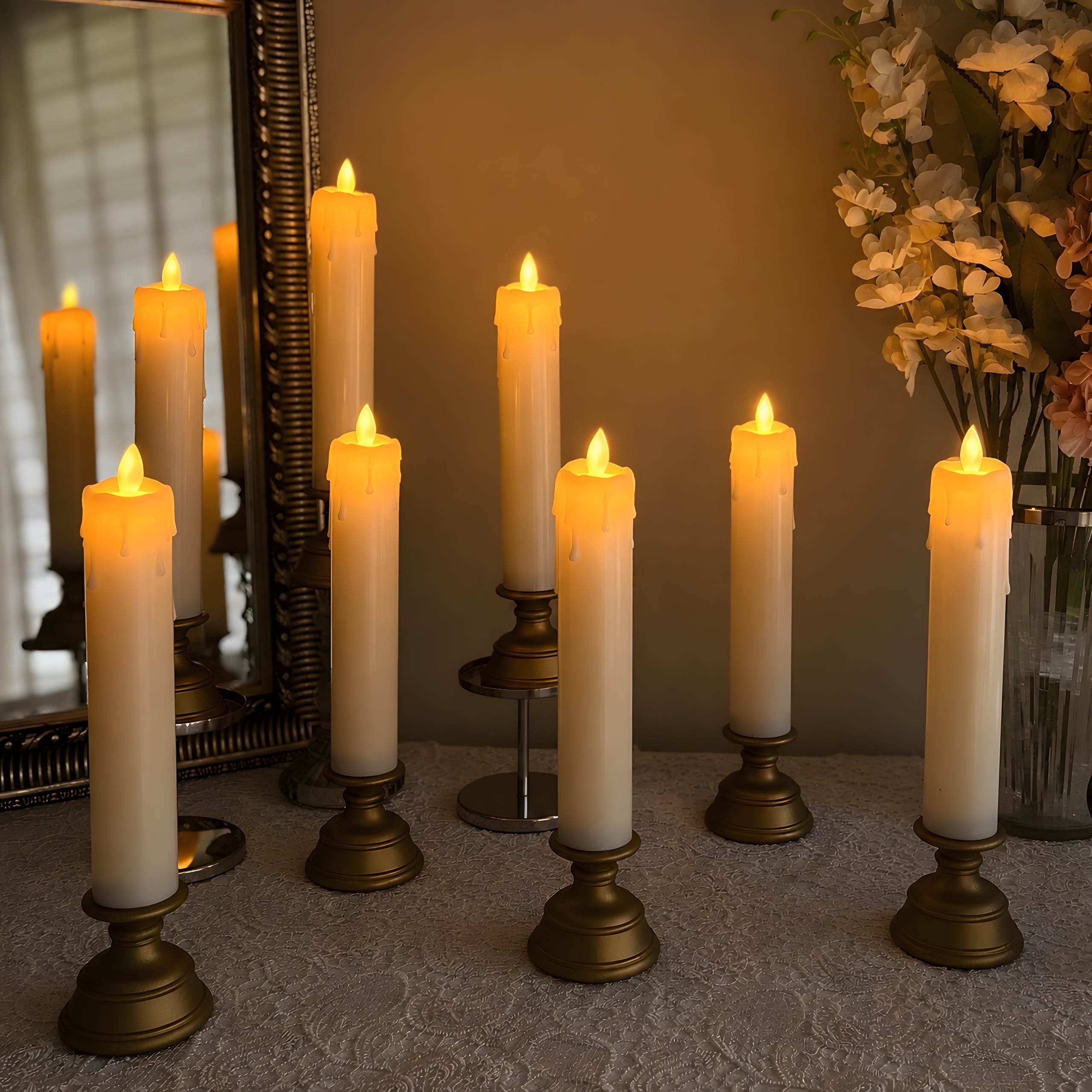 LED pillar candles with antique-gold stands in a warm candlelit display with mirror and flowers