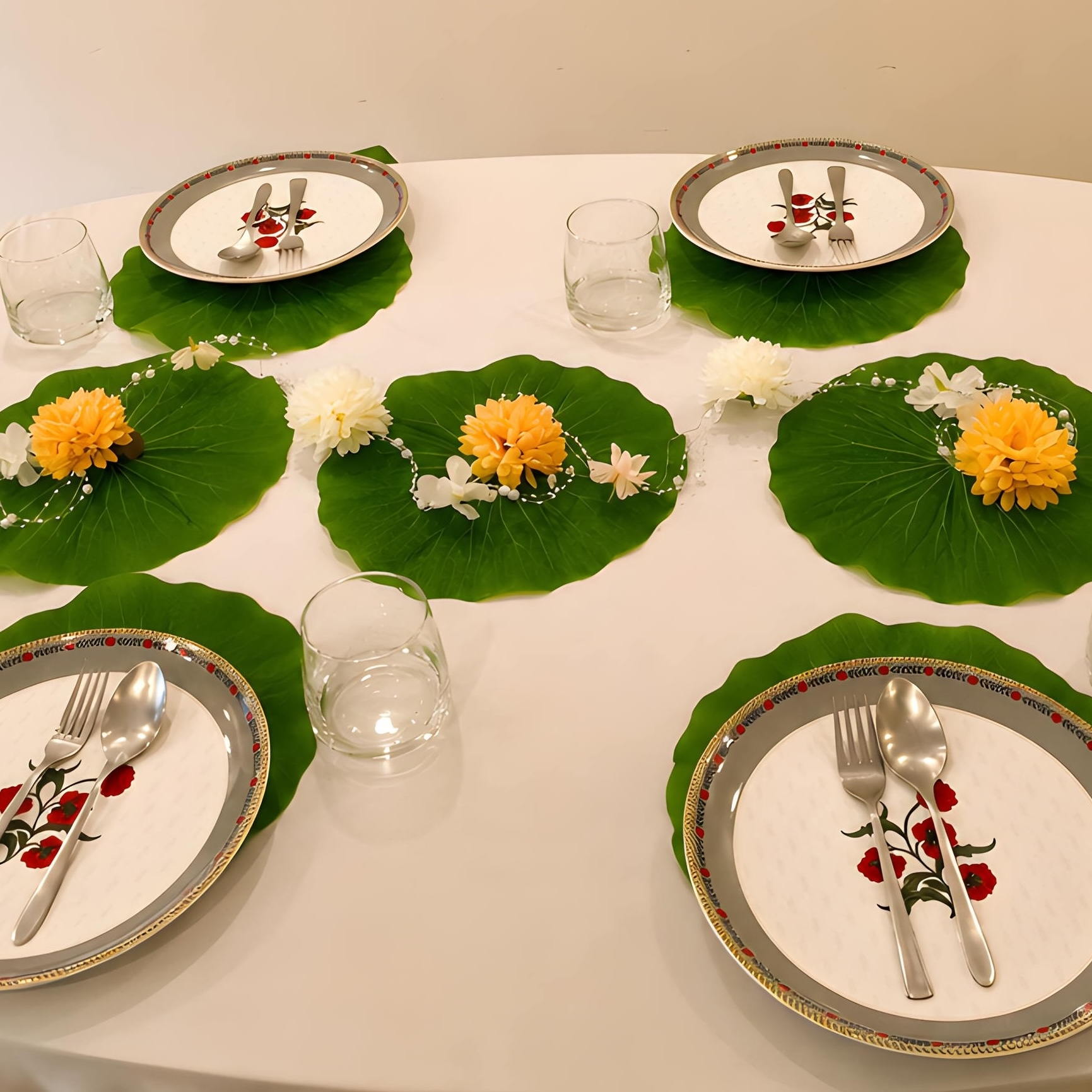 Round dining table set with lotus leaf place mats and marigold accents