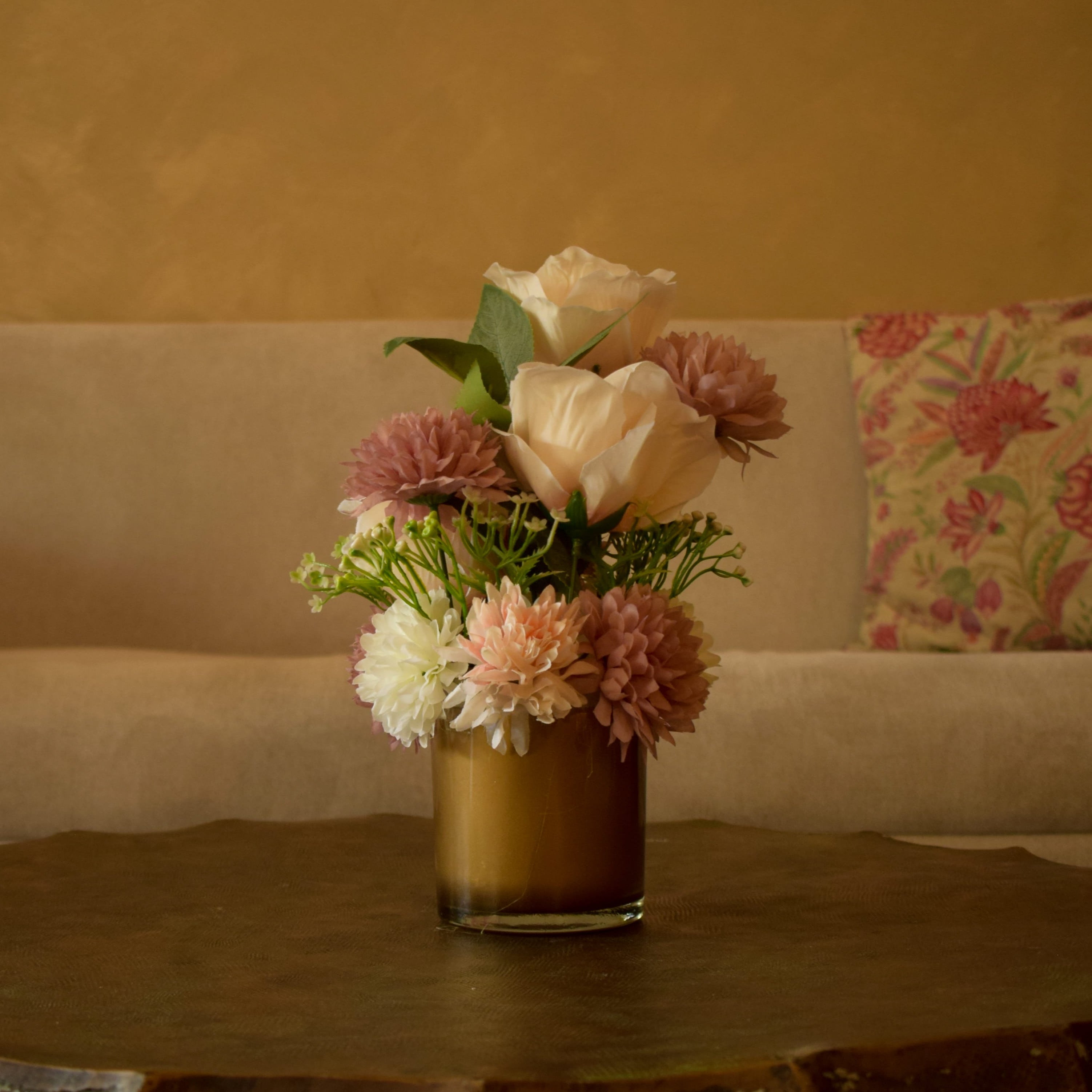 Artificial flowers arranged in a glass vase by Floral Art by Nandini