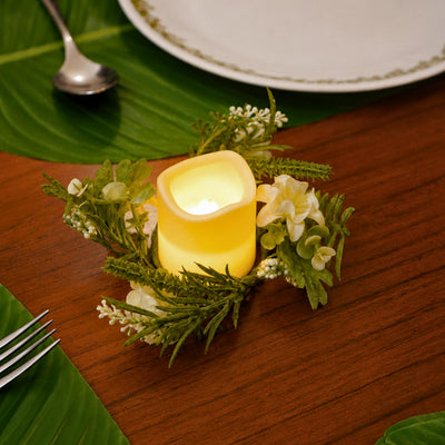 Three Amalfi Candle Rings on a wooden tray on a coffee table beside a sofa