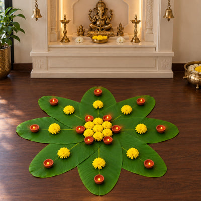 Banana leaf rangoli with LED diyas and marigolds in front of the mandir