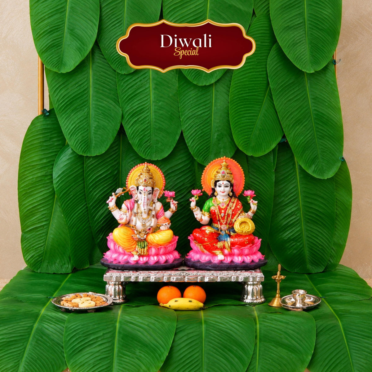 Diwali Special banana leaf backdrop behind Lakshmi and Ganesh idols with a silver chowki and puja thali