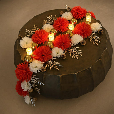 Overhead red and white flower runner with gold baubles on a tray