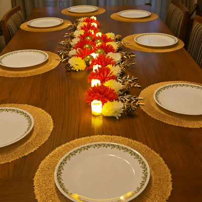 Wood dining table with the red and white flower runner and plates