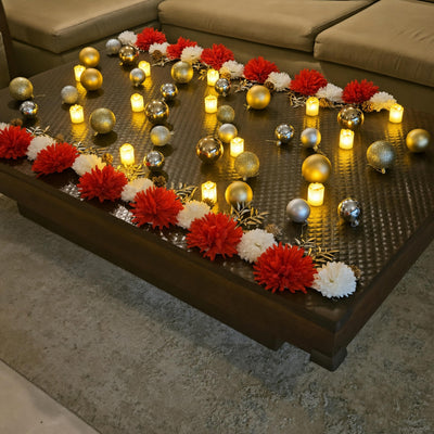 Coffee table with the red and white flower runner and gold baubles