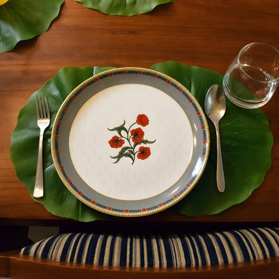 Single lotus leaf place mat under a floral dinner plate
