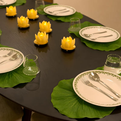 Evening dining table with lotus leaf mats and LED lotus lights