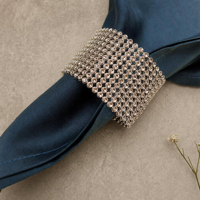 Silver rhinestone napkin ring band on a navy napkin